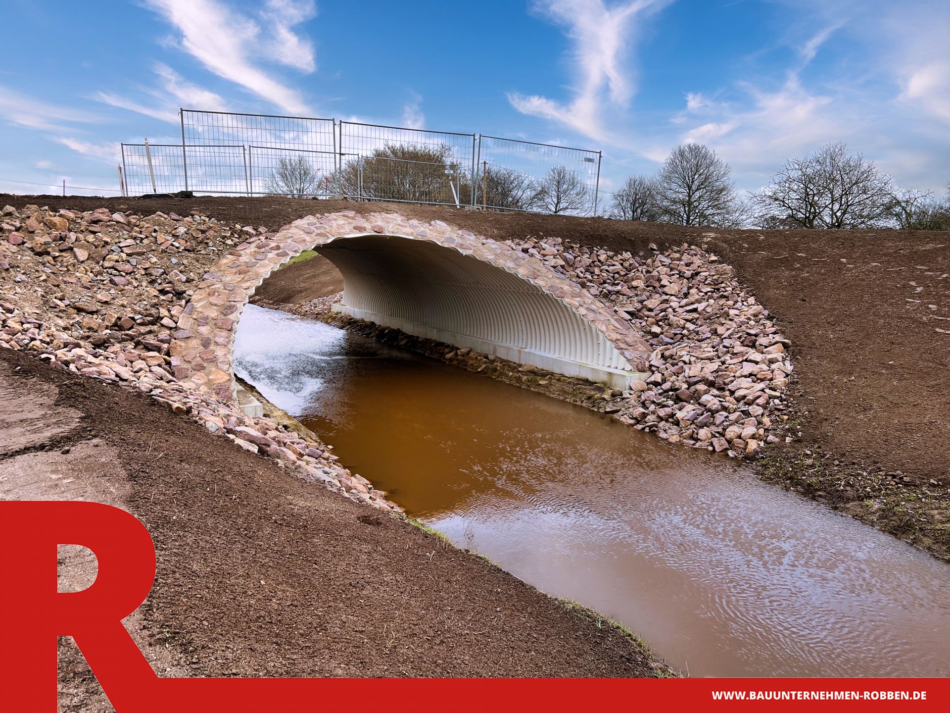 Rahmendurchlass an Stelle einer Brücke über einem Schloot in grauem Beton.