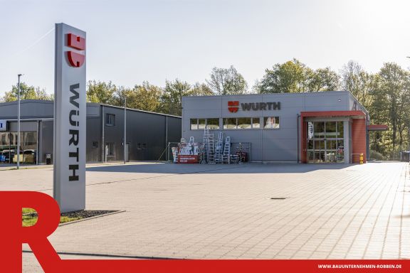 Gewerbebau eines grau-roten Fachmarkt f&uuml;r Montagetechnik.