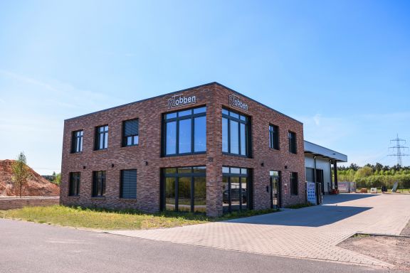 Anfahrt Bürogebäude der Bauunternehmen Robben GmbH mit anliegender Lagerhalle.